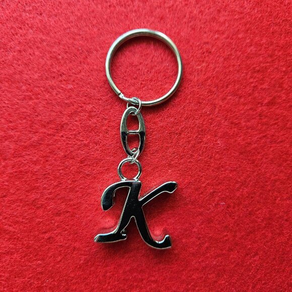 Crafted from polished silver-tone metal elegant keychain features the letter K - Picture 1 of 5